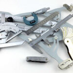 A set of gauges and precision measuring equipment including a Vernier protractor, callipers, fixed radius gauges and the Arc Master adjustable radius gauge.