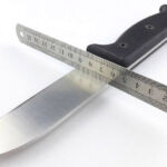 Using a straight-edge to confirm the primary bevel type.